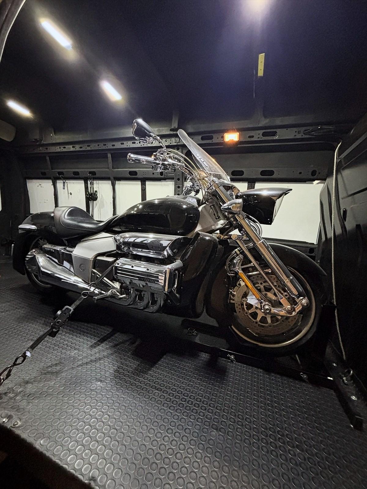 Silver and black Honda Valkyrie Rune, strapped inside the MC Station van